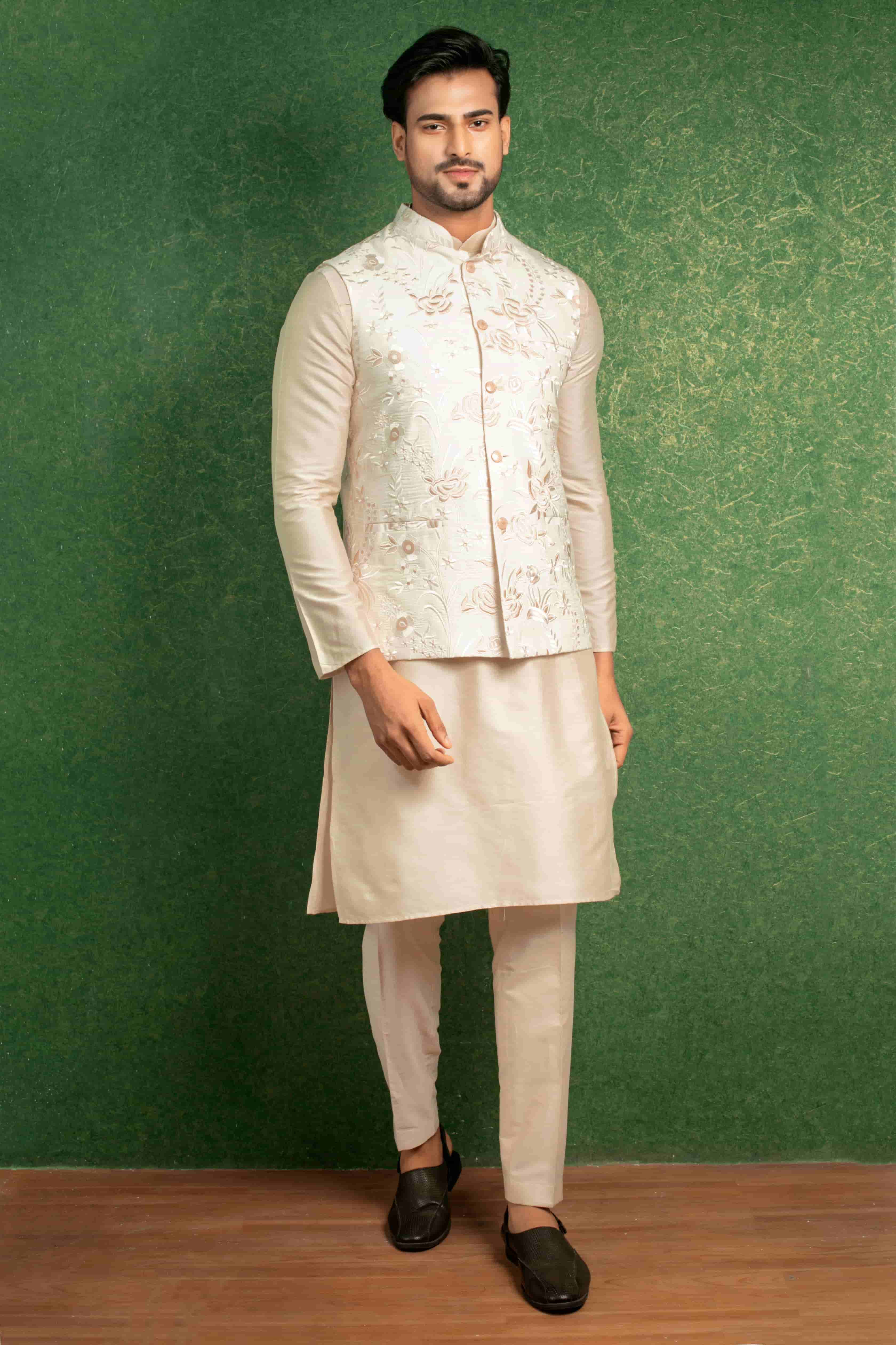 Light beige katan silk kurta and straight fit trousers paired up with an off-white embroidered nehru jacket.